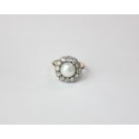 A pearl and old cut diamond cluster ring in 18ct gold with a ten stone border