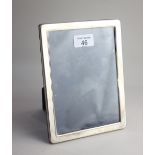 A modern silver mounted rectangular photograph frame on easel stand 20cm hiigh