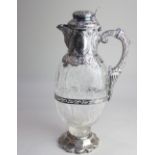 A late Victorian silver mounted cut glass claret jug the collar with oval panels, spout and handle