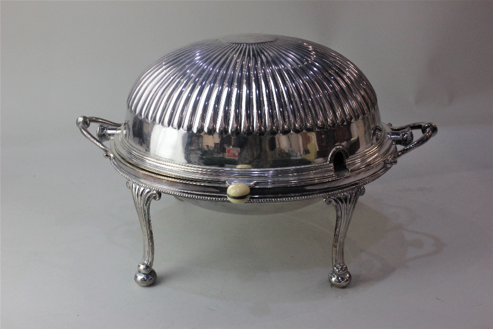 A silver plated two handled revolving oval domed tureen with fitted dish and liner, reeded top on