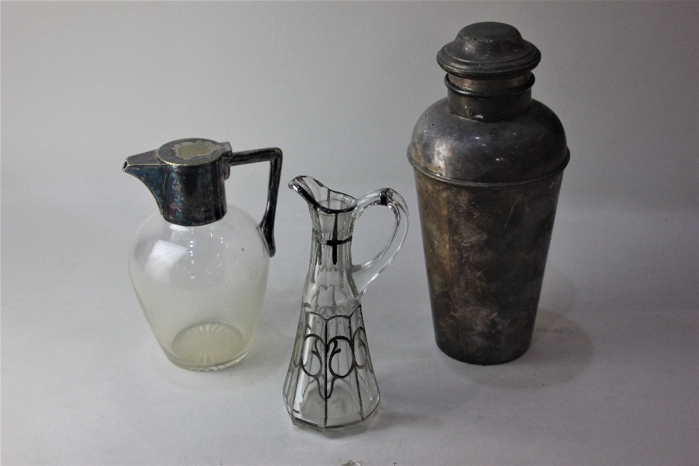 A silver plated cocktail shaker 24cm a silver plate mounted glass claret jug and a silver overlay