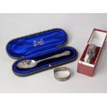 A cased Victorian silver christening spoon with cast scroll decoration, London 1899, a later cased