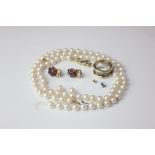 A single row cultured pearl necklace, a pair of garnet ear clips, a silver ring with beaded band (