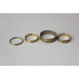 Two 9ct gold rings with textured decoration and two yellow metal rings