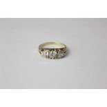 A three stone diamond ring the brilliant cut stones set in 18ct gold 4.8g