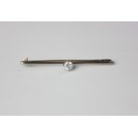 A diamond single stone bar brooch eight claw set