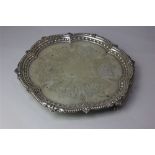 A George V silver salver engraved decoration of fruit and flowers within shaped bead and harebell