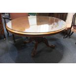 A Victorian walnut loo table, with quarter-veneered oval tilt top above carved baluster stem on four