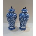 A pair of Chinese blue and white porcelain vases and covers, baluster shaped, decorated with