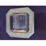 A Rene Lalique 'Paquerettes' square canted glass dish moulded with flowers highlighted in green,