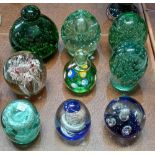 Nine various large glass paperweights including green bubble glass examples
