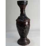 A Japanese bronzed metal vase decorated in relief with birds and blossom, character marks to base,