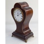 An Edwardian balloon shaped mantle clock white dial with Roman numerals on plinth base and metal