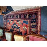 A Persian carpet, red ground, with central flower patterned panel, within multiguard border,