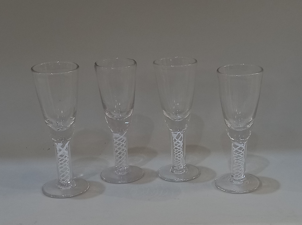 Four similar wine glasses with air twist stems