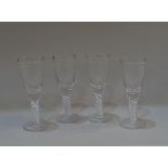 Four similar wine glasses with air twist stems