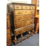 A Queen Anne style walnut and cross banded chest on stand, with three short over three graduated