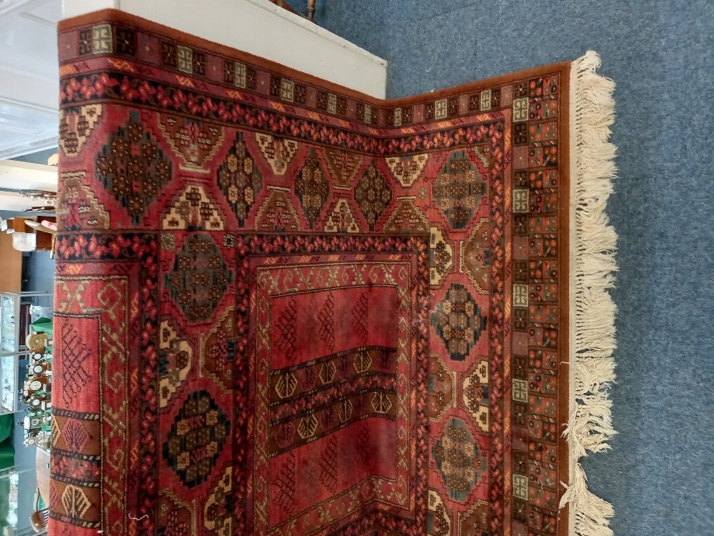 A Louis de Poortere 'Mossoul' rug, red ground, with geometric decoration, label verso, 170cm by