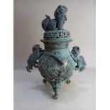 A Chinese metal censer, green patina, the lid with Dog of Fo finial, on three feet 47cm high (a/f)