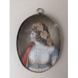 An 18th/19th century portrait miniature of a lady with grapes and leaves in her hair, oval, 8.5cm by