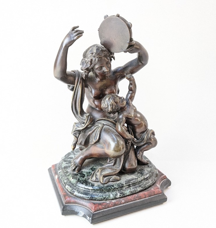 A 19th century bronze figure group of a woman holding tambourine beside a child, on marble base,