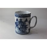 A Chinese blue and white porcelain tankard, with wavy rim and crossover handle, decorated with a