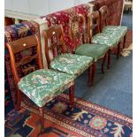 A set of four Victorian dining chairs with scroll and tablet bar backs, upholstered seats on