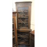 A mahogany glazed corner cabinet with dentil carved and blind fret cornice, top and base with glazed