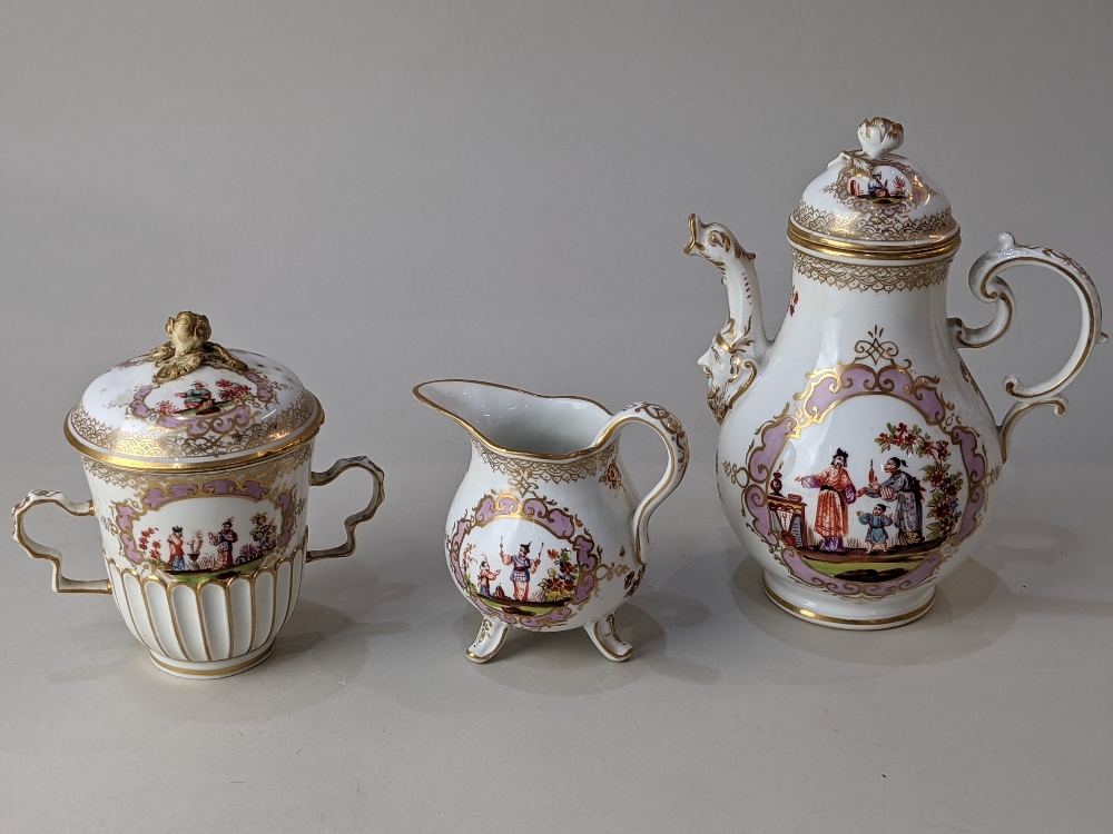 A Meissen style porcelain chocolate pot, cream jug and chocolate cup and cover, decorated with