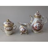 A Meissen style porcelain chocolate pot, cream jug and chocolate cup and cover, decorated with