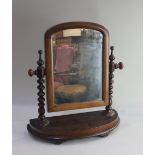 A Victorian dressing table mirror arched glass on bobbin turned supports and curved base, 48cm