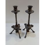 A pair of cast bronzed metal candlesticks with urn sconces on narrow reeded stems and three