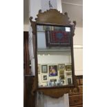 A walnut fret cut wall mirror, rectangular mirror plate 44cm by 27cm