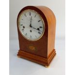 LOT WITHDRAWN A Comitti Regency style arch top mantle clock, the circular dial with Roman numerals,