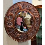 A William Henry Mawson for Keswick copper framed wall mirror, of circular form, with bevelled mirror