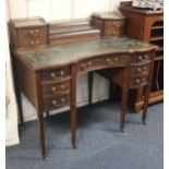 An early 20th century mahogany desk by Hamptons Pall Mall, London concave top with green leather top