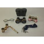 A cased pair of opera glasses, two other pairs including one with mother of pearl and adjustable