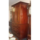 A mahogany secretaire linen press cupboard in the manner of Gillows top with flame veneer doors