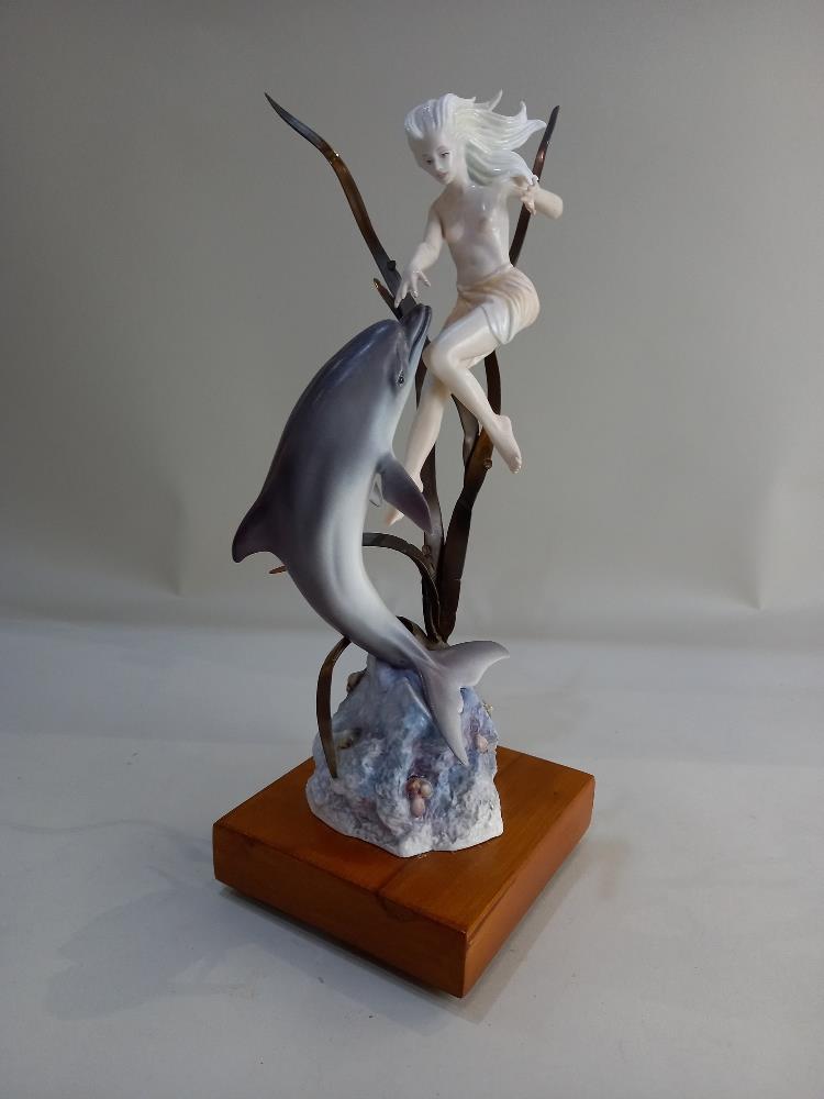 An Albany Fine China model of a semi nude female with a dolphin, with metal sea grasses, mounted