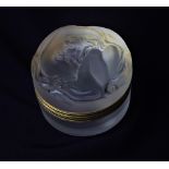 A Lalique 'Daphne' powder box, the lid moulded with a sinuous nude figure, 8cm diameter