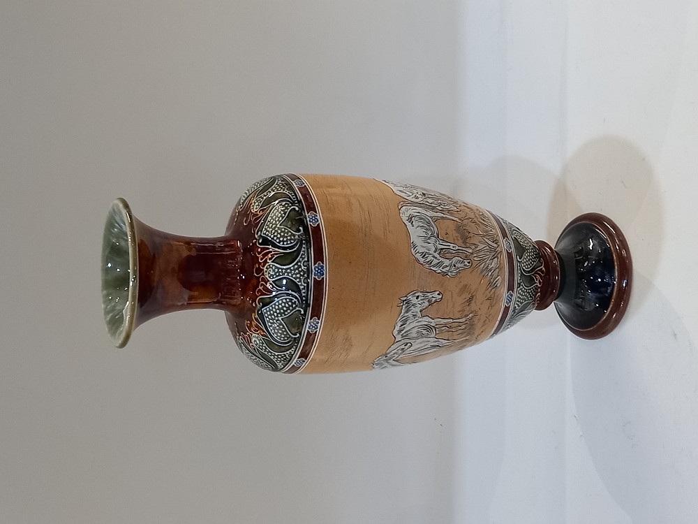 A Royal Doulton stoneware vase decorated by Hannah Barlow, incised with a band of horses, with