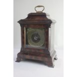 A George III style oyster veneered mantle clock case with brass carry handle, chapter ring and
