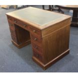 An Edwardian banded mahogany pedestal desk, with green leather inset rectangular top above an