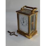 A brass carriage clock white dial with Roman numerals 15cm