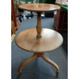 A 19th century mahogany dumb waiter, with two circular tiers and turned stem on three legs with