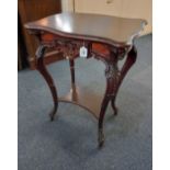 A carved mahogany side table with shaped top and drawer on floral carved cabriole legs with