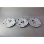Three Ludwigsberg porcelain plates, each with floral decoration on white ground, 23.5cm diameter
