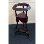 A George III mahogany circular washstand with ring top washbowl support, two triangular shaped