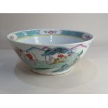 A Chinese porcelain bowl, with polychrome decoration of figures in a landscape with river, 29cm