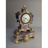 A 19th Century French porcelain mantle clock, the white enamel dial with Roman numerals, movement